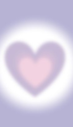 a blurry image of a pink heart on a purple and light blue background with white clouds