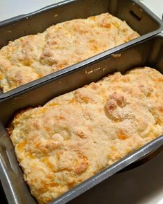 two pans filled with baked food sitting on top of a stove next to each other