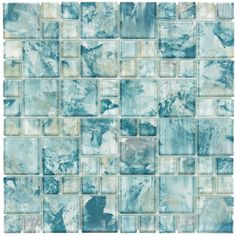 a blue and white tile wall with squares on it's sides, all in different shades