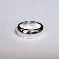 This is a beautiful, heavy sterling band ! This ring is very comfortable and makes a statement on it's own. This piece is great to wear everyday. It is ever so slightly tapered and measures 7.5 mm to 7 mm wide. The depth is 3mm. This ring can be custom made up to a size 8. This ring can be ordered in silver, gold and platinum. Sterling Silver Bands, Silver Band, Band Rings, Silver Gold, Custom Made, Platinum, Jewelry Rings, Band, Sterling Silver