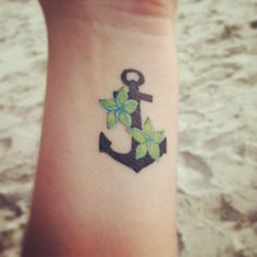 an anchor with flowers on the wrist is seen in this image, it appears to be embroidered onto someone's arm