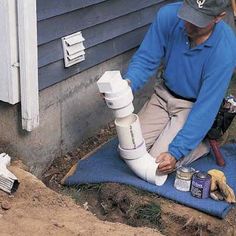 a man working on a pipe in the ground