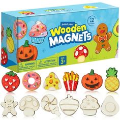 the wooden magnets are set up in front of a box with different designs on it