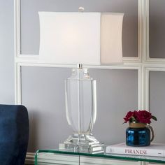 a glass table with a lamp on it