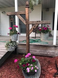 potted flowers are sitting on the porch