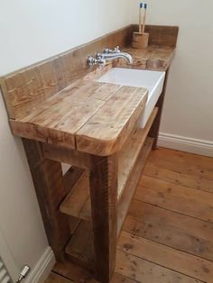 a bathroom sink made out of wooden planks