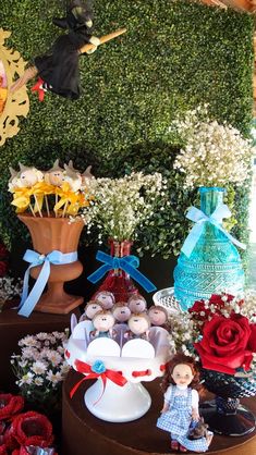 there are many different items on display in this room, including flowers and stuffed animals