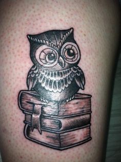 an owl is sitting on top of a book