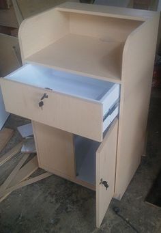 an unfinished wooden desk with drawers on it