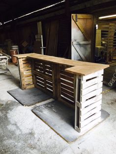 a wooden table sitting inside of a garage