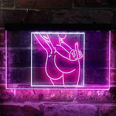 a neon sign that is on the side of a brick wall