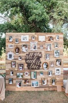 a wooden wall with pictures on it that says all you need is love