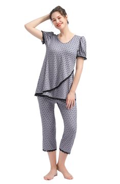 A supersoft pajama top is designed to adapt to your changing body during and after pregnancy with a flattering V-neckline and a flowy tulip-style hem. Comfy capri-length pants and inky lace trim complete the cozy sleep set. 27" top length; 21" inseam; 18" leg opening; 15 1/2" rise Top has V-neck; short sleeves 95% rayon, 5% spandex Machine wash, tumble dry Imported Spring Nursing Friendly Sleepwear, Cozy Sleep, Maternity Pajamas, After Pregnancy, Sleep Set, Pajama Top, Lace Trim, Pants Set, Capri Pants