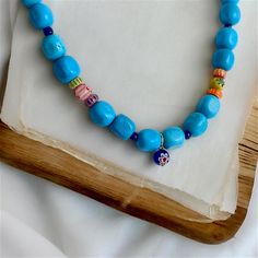 This handmade necklace is made of turquoise natural stone, glass and various beads. The necklace length is approximately 40 cm. My designs are unique like every woman. That's why I only make one of each, I'm sure you will enjoy wearing them as much as I do. Please do not hesitate to contact me for any questions. Colorful Beads Turquoise Necklace For Beach, Beach Turquoise Necklace With Round Beads, Blue Bohemian Wooden Beads Necklaces, Turquoise Bohemian Jewelry With Letter Beads, Bohemian Turquoise Beaded Necklace With Letter Beads, Turquoise Necklace With Large Beads For Beach, Turquoise Necklace With Round Gemstone Beads For Beach, Blue Wooden Beads For Jewelry Making, Bohemian Light Blue Beads For Gift