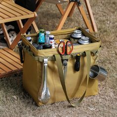 a picnic bag with utensils in it sitting on the ground