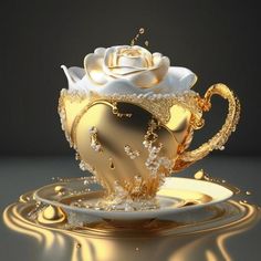 a gold and white tea cup with a rose in it on top of a plate