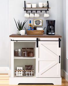 a coffee bar with two shelves and cups on the top, along with other items