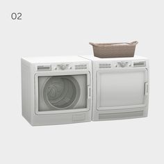 two washers and a dryer sitting side by side on top of each other