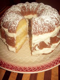 a cake on a plate with one slice cut out