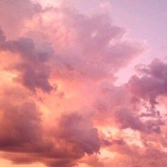 an airplane is flying in the sky at sunset