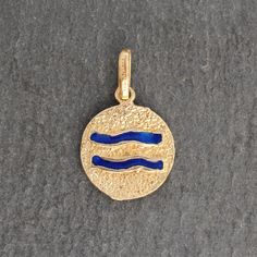 This beautiful vintage Aquarius zodiac pendant is made of 18k yellow gold. It features a double sided style with a textured yellow gold backing and blue, red and green enamel details. ⊹ Vintage 18k Yellow Gold + Enamel⊹ Excellent vintage, pre-owned condition⊹ Diameter: 13.5mm *Note- Pendant does NOT come with chain shown in image- chain is solely shown for perspective* Vintage Yellow Gold Zodiac Jewelry, Yellow Gold Zodiac Sign Charm Pendant Necklace, Yellow Gold Zodiac Amulet Necklace, Yellow Gold Zodiac Pendant Necklace, Aquarius Pendant, Zodiac Pendant, Aquarius Zodiac, Green Enamel, Gold Enamel