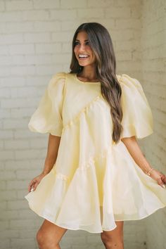 This timeless yellow dress is crafted from a high-quality organza fabric, offering a luxe feel. The dress features puff sleeves and is lined for a comfortable and flattering fit. Make a statement in this elegant and chic style. 100% Polyester Size Rec: 4-6:S, 8:M, 10-12:L size down if between sizes Model is 5'6" with a 35" bust, 26" waist, and 36" hips wearing a size small. Organza Fabric, Puffed Sleeves Dress, Yellow Dress, Trending Now, Puff Sleeves, Puff Sleeve, Chic Style, The Dress, Yellow