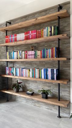 a bookshelf filled with lots of books next to a wall mounted planter