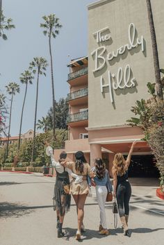 three women standing in front of the beverly hotel