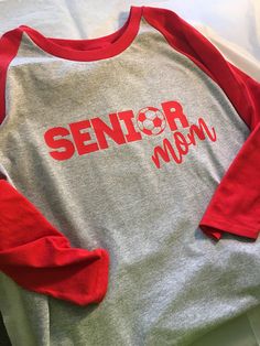 Senior Mom Shirt Senior Soccer Mom Senior Night Shirt White Long Sleeve Sleepwear With Letter Print, Custom Print Long Sleeve Top For College, Custom Print Long Sleeve College Tops, Long Sleeve Tops With Name Print For Team Spirit, Long Sleeve Sports Top With Name Print, Red Long Sleeve Tops With Custom Print, Red Long Sleeve T-shirt For School Spirit, Red Custom Print Tops For College, School Spirit Long Sleeve Shirt With Letter Print