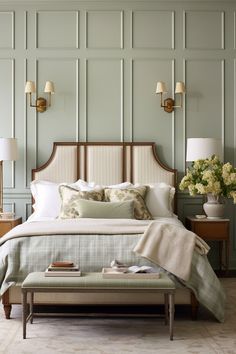 a large bed sitting next to two lamps on either side of the headboard and foot board