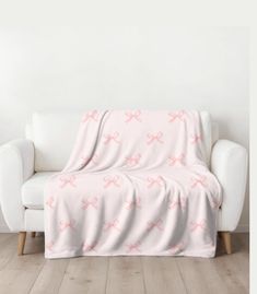 a white couch with pink crosses on it