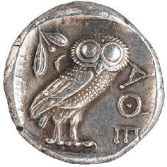 an ancient coin with an owl on it