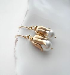 "Bridgerton Style White Pearl and Gold Drop Earrings. These beautiful earrings are made from vintage raw brass bead caps, Swarovski white cream pear shaped pearls and gold plated findings. They are about 1\" tall. Check out my store to see more of my creations http://www.etsy.com/shop/anechkasjewelry Thank you for looking!" Elegant Brass Flower Earrings For Wedding, Vintage White Bridal Earrings As Gift, Vintage White Bridal Earrings For Gift, White Vintage Bridal Earrings As Gift, White Brass Pearl Earrings For Wedding, White Vintage Bridal Earrings, Vintage White Bridal Earrings, Handmade Gold Bridal Earrings As Bridesmaid Gift, Classic White Earrings With Pearl Charm