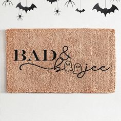 a door mat with bats hanging from it and the words bad & boogie on it