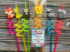 there are many colorful birthday candles with animals on them and a sign that says happy birthday