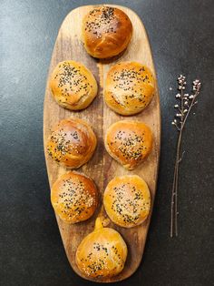 bread rolls with poppy seed sprinkles on a wooden board