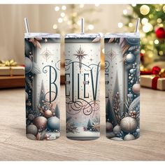 three christmas themed tumblers sitting on top of a wooden table