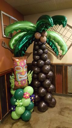 balloons and palm trees are on display in an office