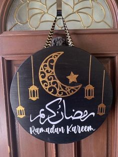 a wooden sign hanging from the side of a door that says, ramadan kareen