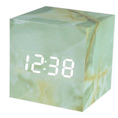 a clock that is on top of a marble block with the numbers 8 - 9