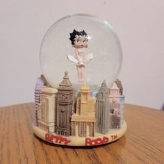 a snow globe sitting on top of a wooden table