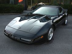 a black sports car parked in a parking lot