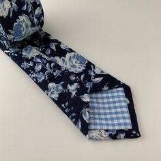 This handmade floral tie is an excellent accessory for weddings, parties, proms - an excellent gift for anyone who enjoys dressing-up dapper! Style: slim/narrow Fabric: 50% cotton / 50% linen Approx. Measurements: (W) 2.4 in. x (L) 58 in. Care: Dry clean only Blue Standard Tie For Wedding, Blue Summer Wedding Ties, Blue Ties For Wedding Neckwear, Fitted Blue Floral Suit And Tie Accessories, Blue Wedding Neckwear With Ties, Blue Fitted Suit And Tie Accessories For Wedding, Blue Wedding Ties, Groomsmen Ties, Groomsman Gift