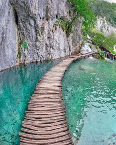 a long wooden path that is in the water