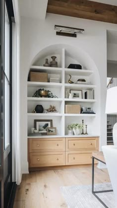 a living room filled with lots of white furniture