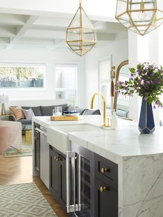 a kitchen with marble counter tops and gold accents