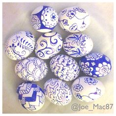 blue and white painted eggs in a bowl