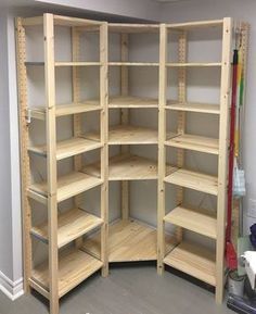 an empty shelving unit is shown in the corner of a room with several shelves