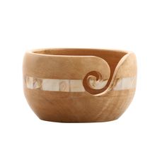 a wooden bowl with swirl designs on it