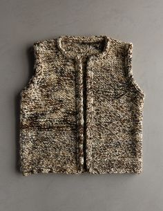 the vest is made out of wool and knitted with an unusual pattern on it